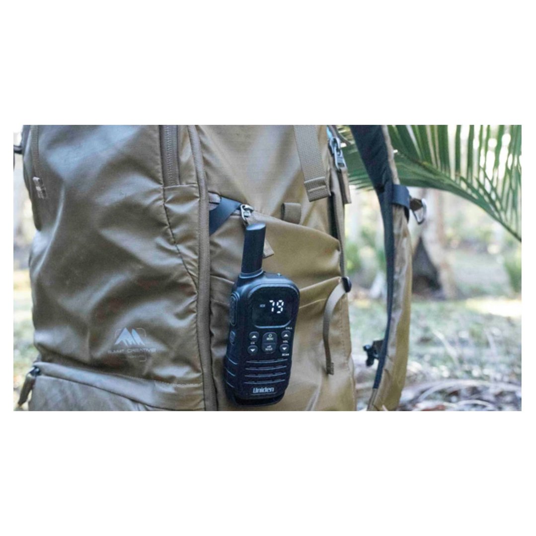 UHF radio attached to a backpack in a natural outdoor setting