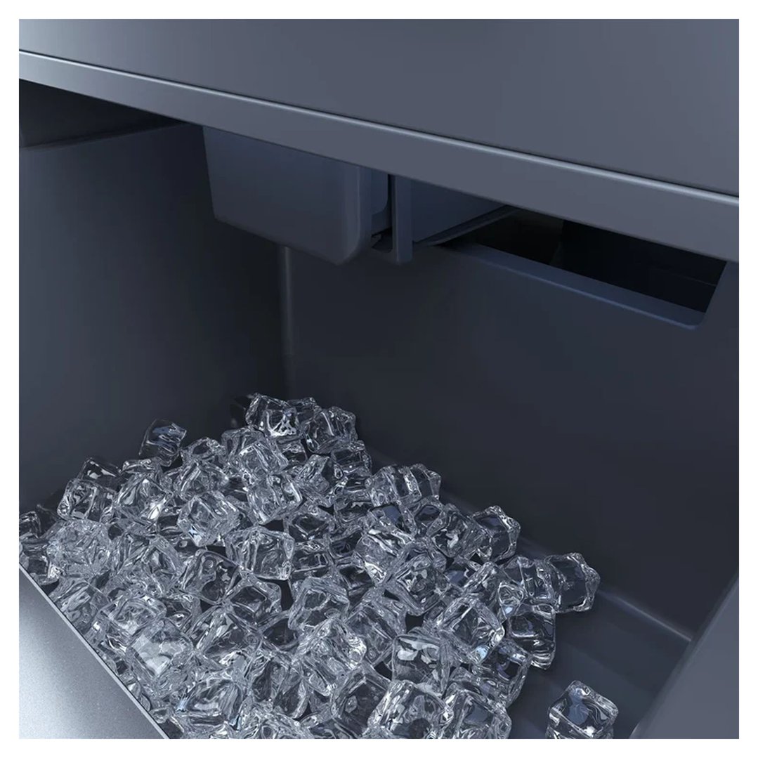 Close up of the ice maker bin filled with ice cubes inside a refrigerator