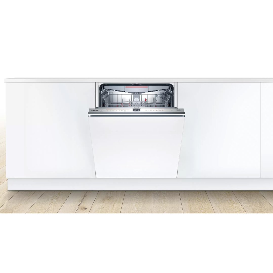 Fully integrated Bosch dishwasher with door open in a white kitchen setting