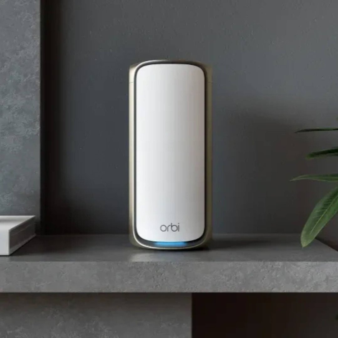 Orbi mesh WiFi router on a grey shelf in a styled room