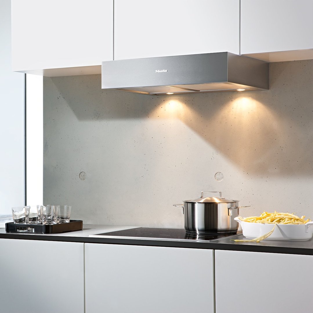 Miele rangehood installed above a cooktop with a pot and bowl of beans