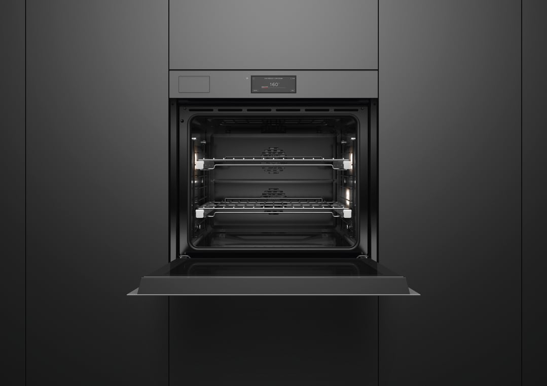 Open grey glass oven with illuminated interior and display showing 160 degrees
