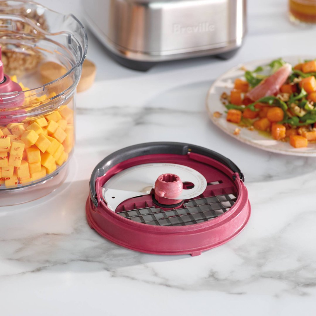 Breville Paradice Kit 9 with diced butternut squash and a salad on a marble counter