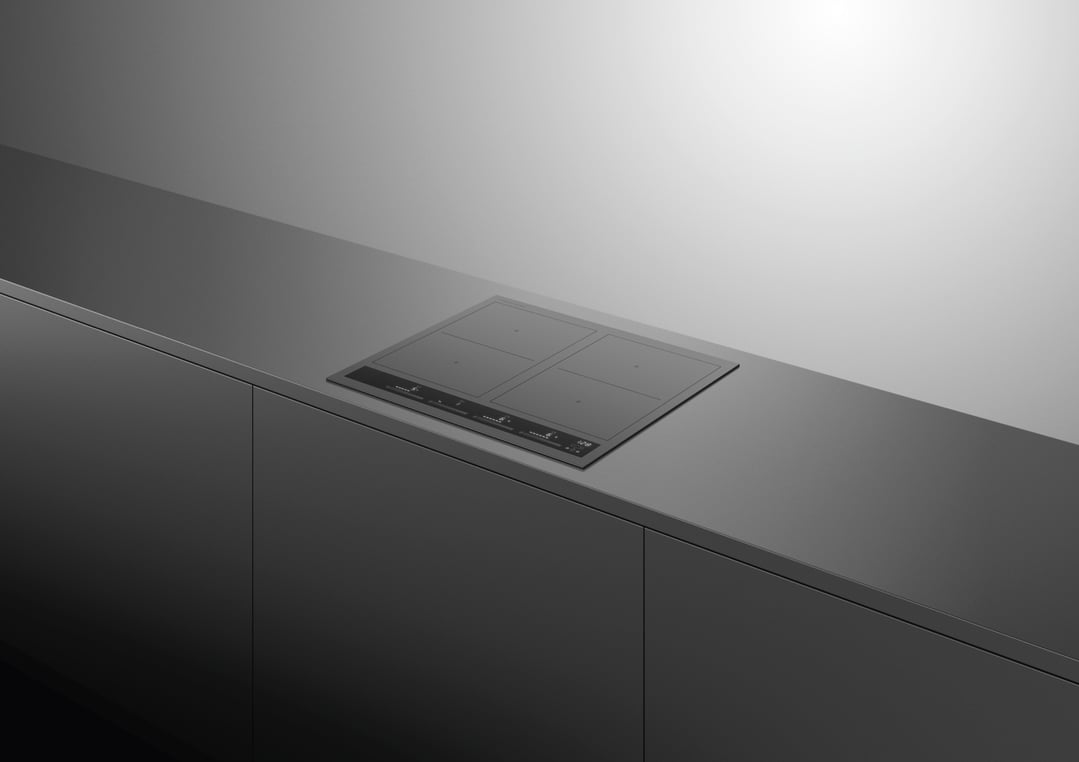 Induction cooktop built into a dark grey kitchen countertop with matching cabinetry