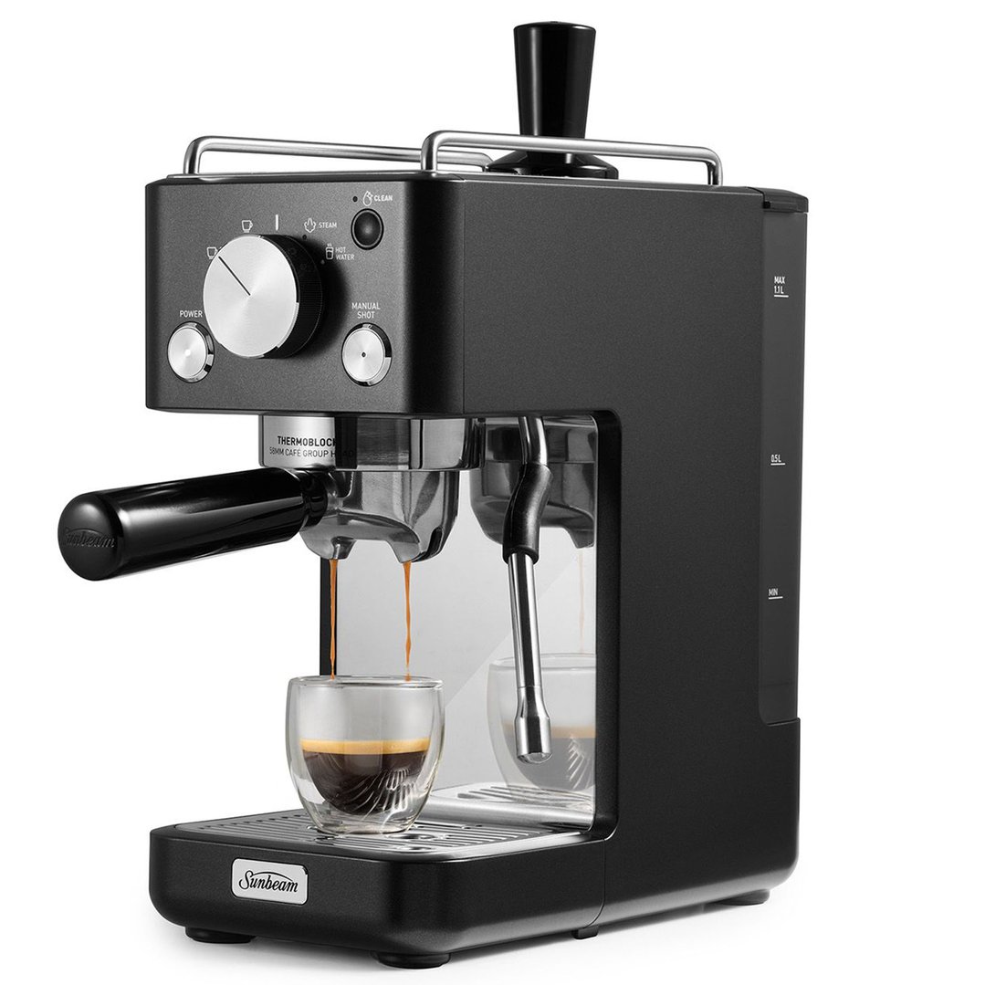 Black espresso machine dispensing coffee into a glass cup on a drip tray