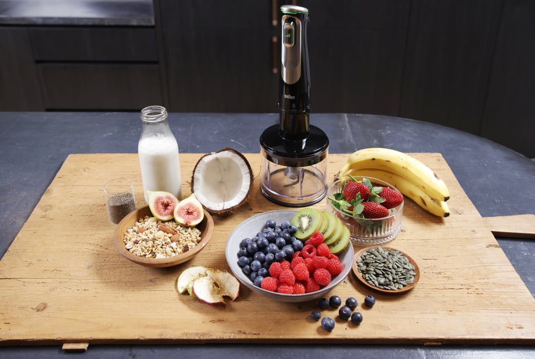 Braun MultiQuick 9 Hand Blender with fruits and ingredients on a wooden board
