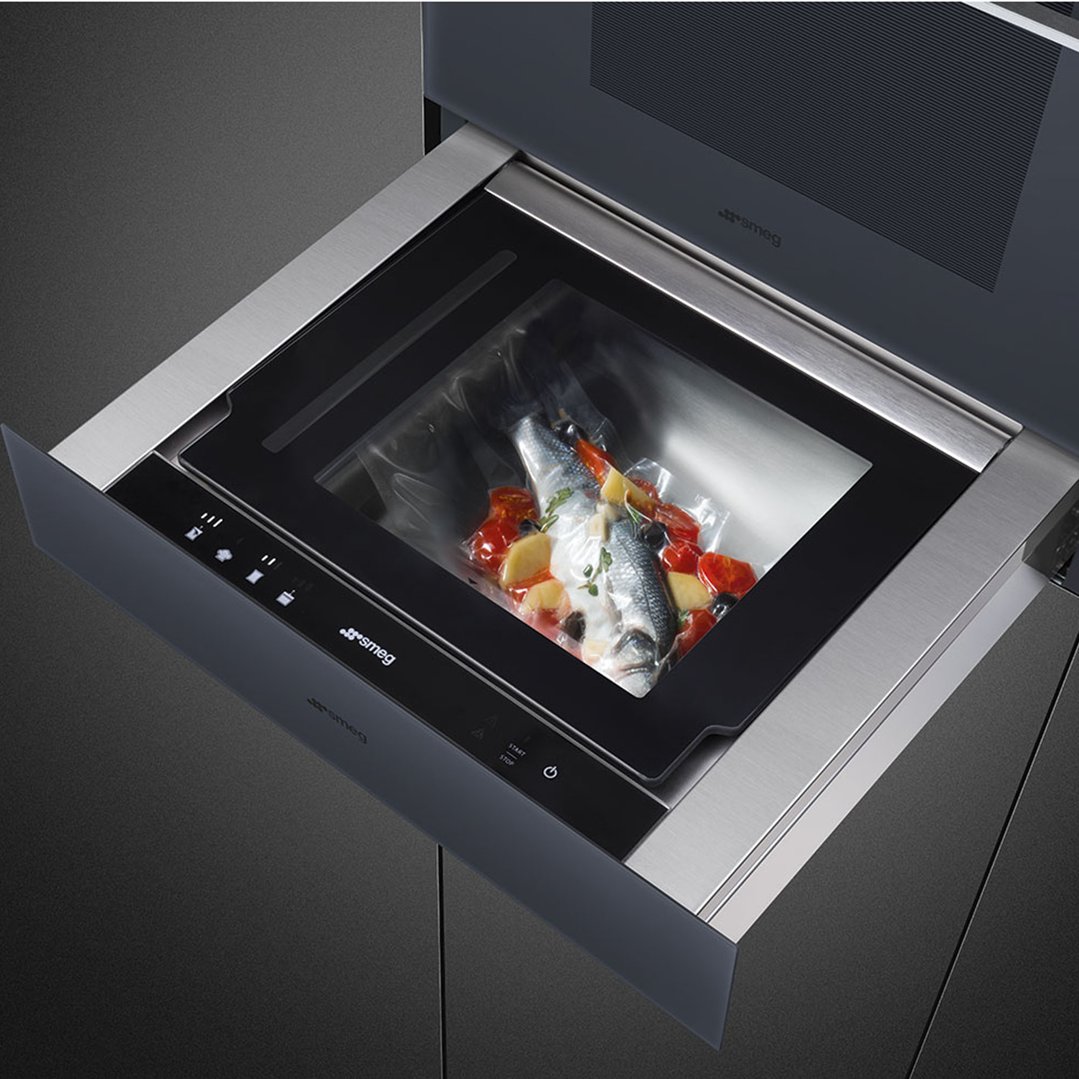 Vacuum drawer with a vacuum-sealed bag of fish and vegetables inside