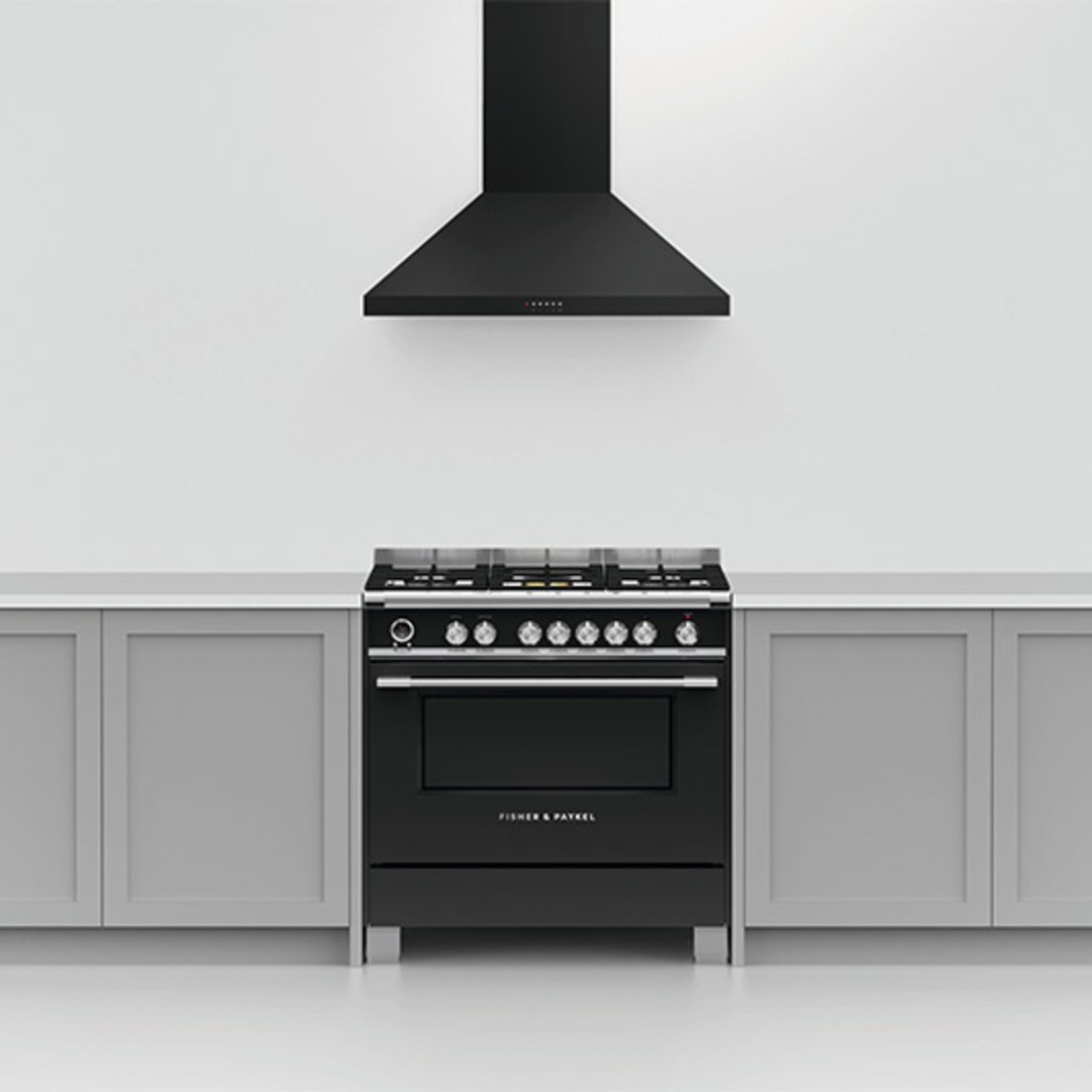 Black rangehood and range cooker in a modern kitchen setting
