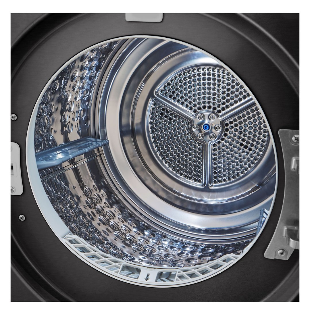 Close-up view inside the drum of a black steel heat pump dryer