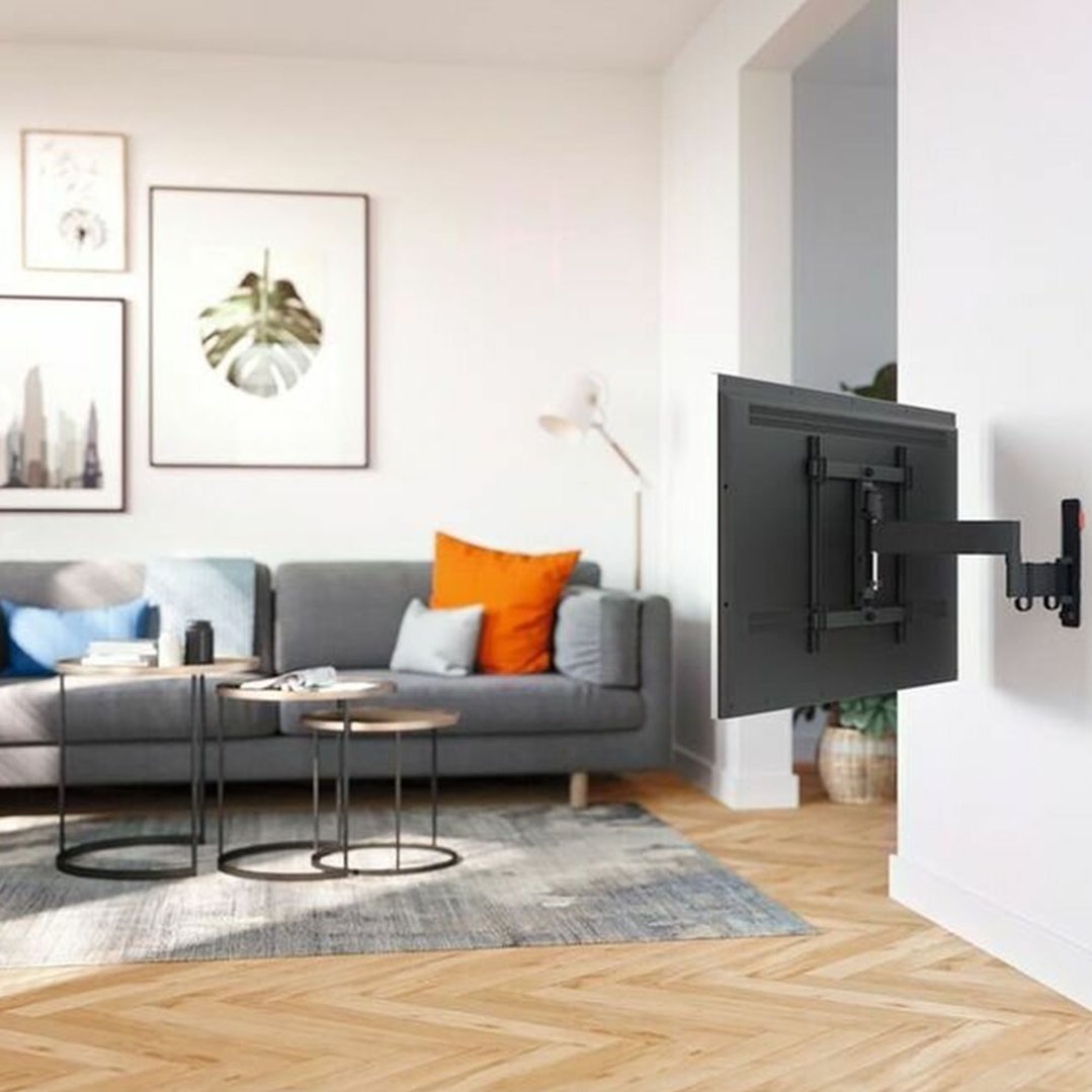 Black TV wall mount with TV attached, extended in a living room