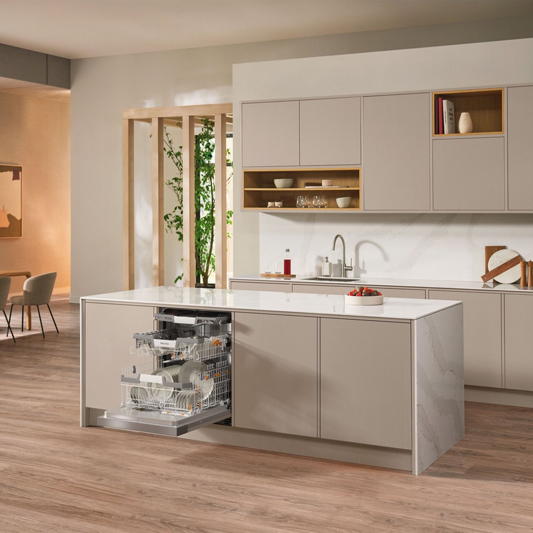 Semi-integrated dishwasher in a modern kitchen island with dishes inside