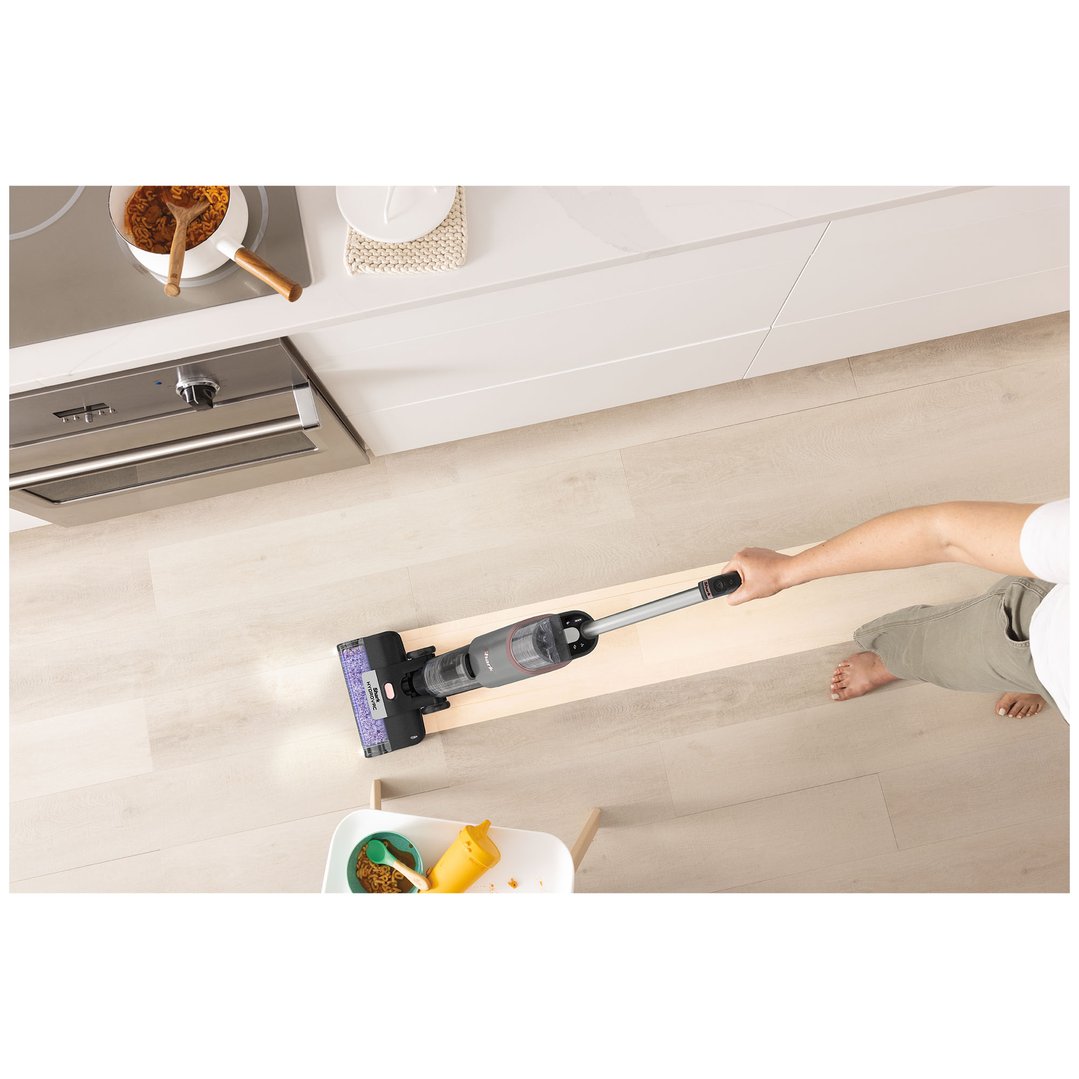 Person using a Shark HydroVac cordless 3-in-1 cleaner on a light wood floor