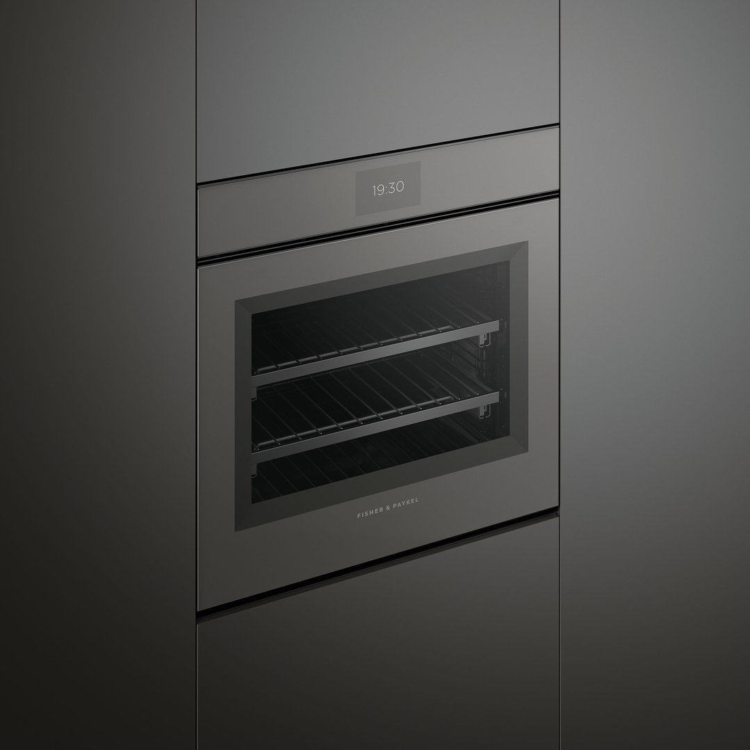 A dark grey built-in combi-steam oven with a digital clock showing 19:30
