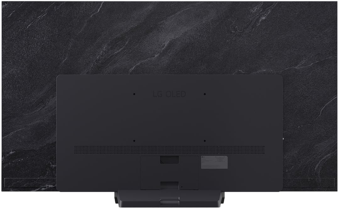 Rear view of a black LG OLED TV on a stand against a dark textured wall