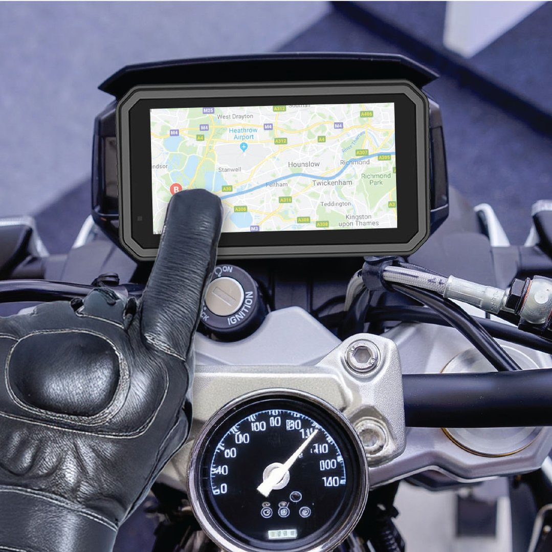 Gloved hand touching a Motorbike CarPlay / Android Auto screen displaying a map
