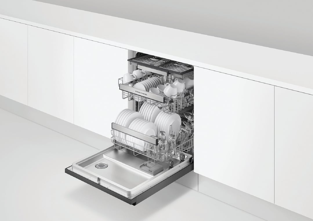 Built-under dishwasher with door open, full of white dishes and glasses