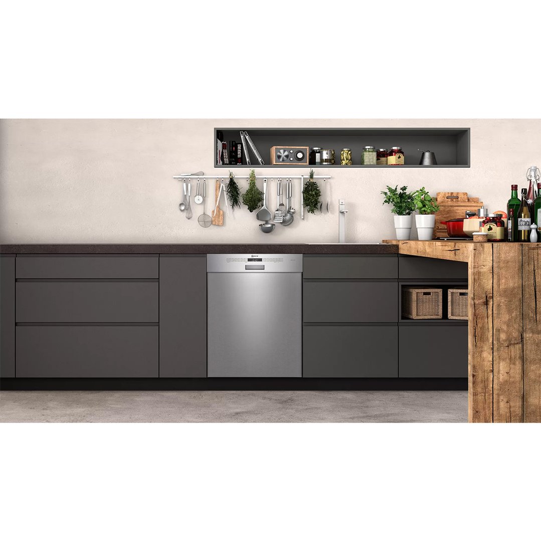 Stainless steel built-under dishwasher in a modern kitchen with dark cabinetry