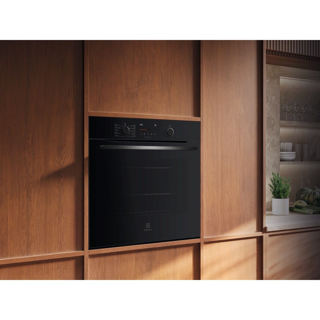 Electrolux 60cm pyrolytic oven built into wooden cabinetry in a modern kitchen
