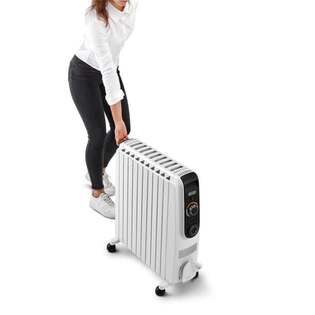 Woman moving a white oil column heater on wheels