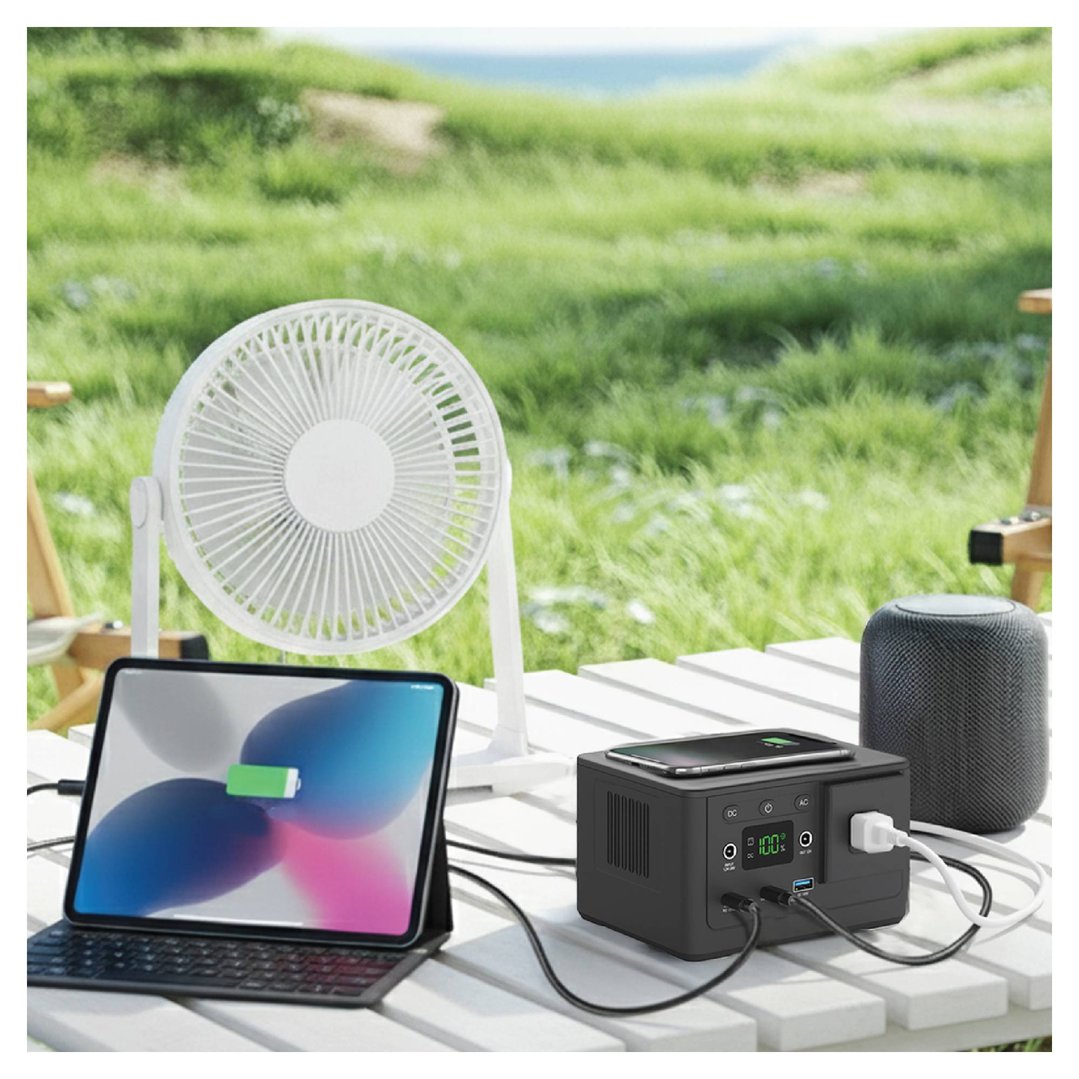 Portable power station charging a tablet and phone on an outdoor table