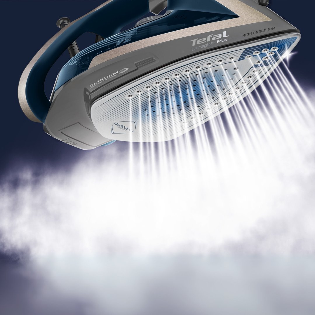 Tefal Ultraglide Plus steam iron releasing steam against a dark background