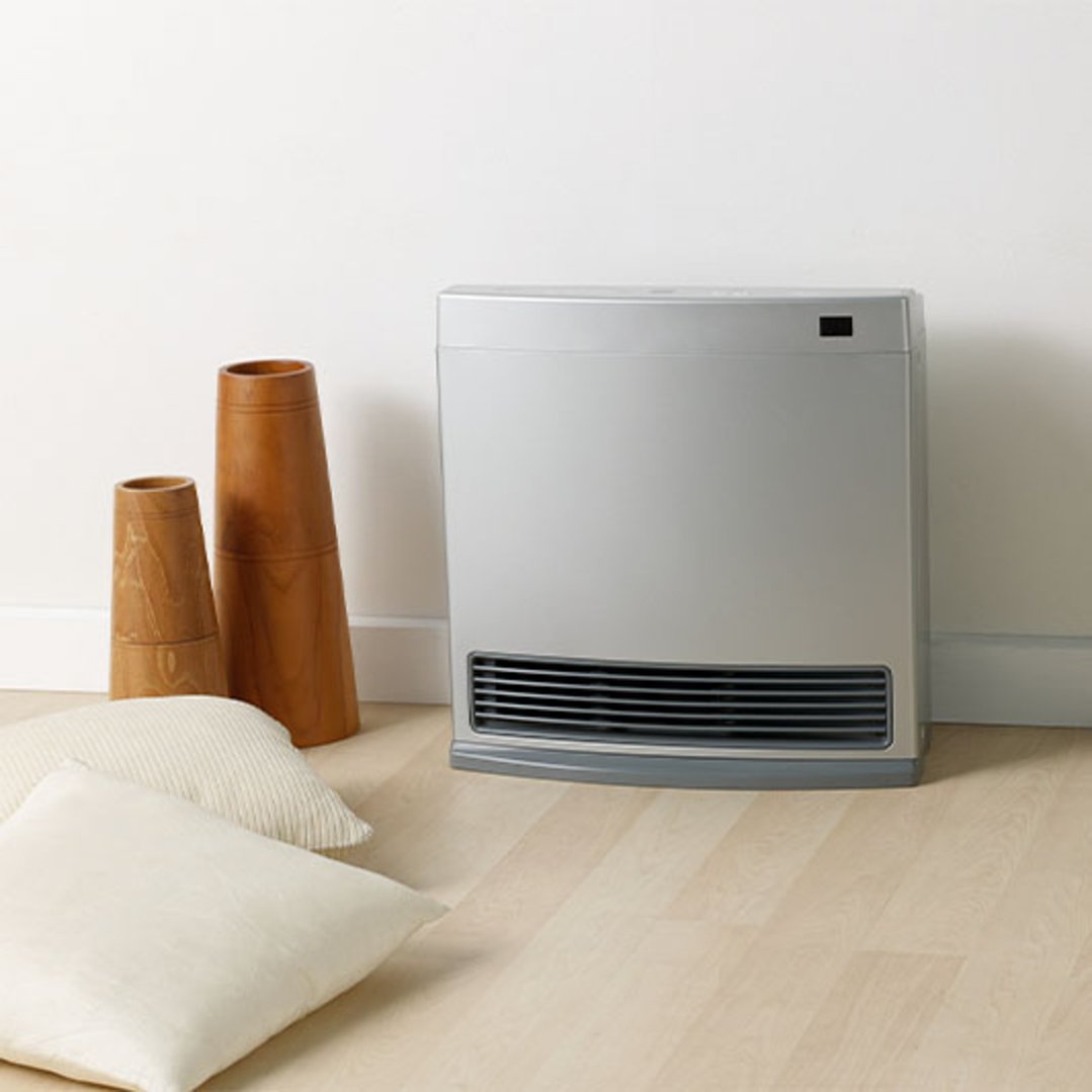 Silver Rinnai Dynamo 15 Convector heater on floor with decorative vases and cushions