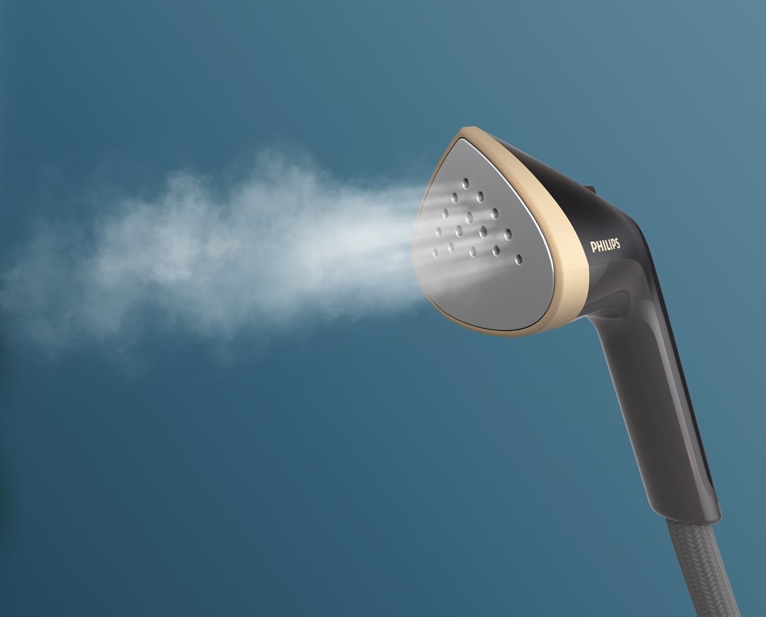 A Philips garment steamer emitting steam against a blue background