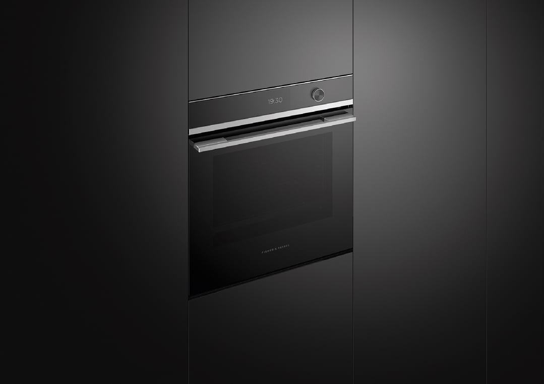 Built-in oven with a digital display showing 19:30 in a dark kitchen