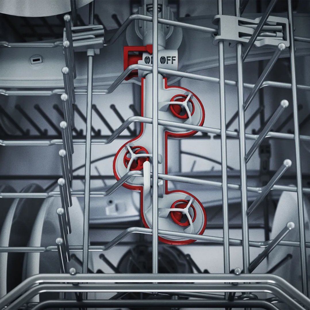 Close up of the interior of a dishwasher with red accents