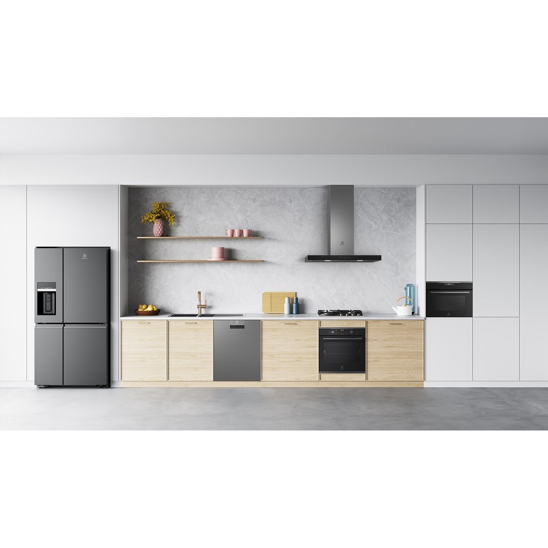 Dark stainless steel oven built into a light wood kitchen cabinet in a modern kitchen