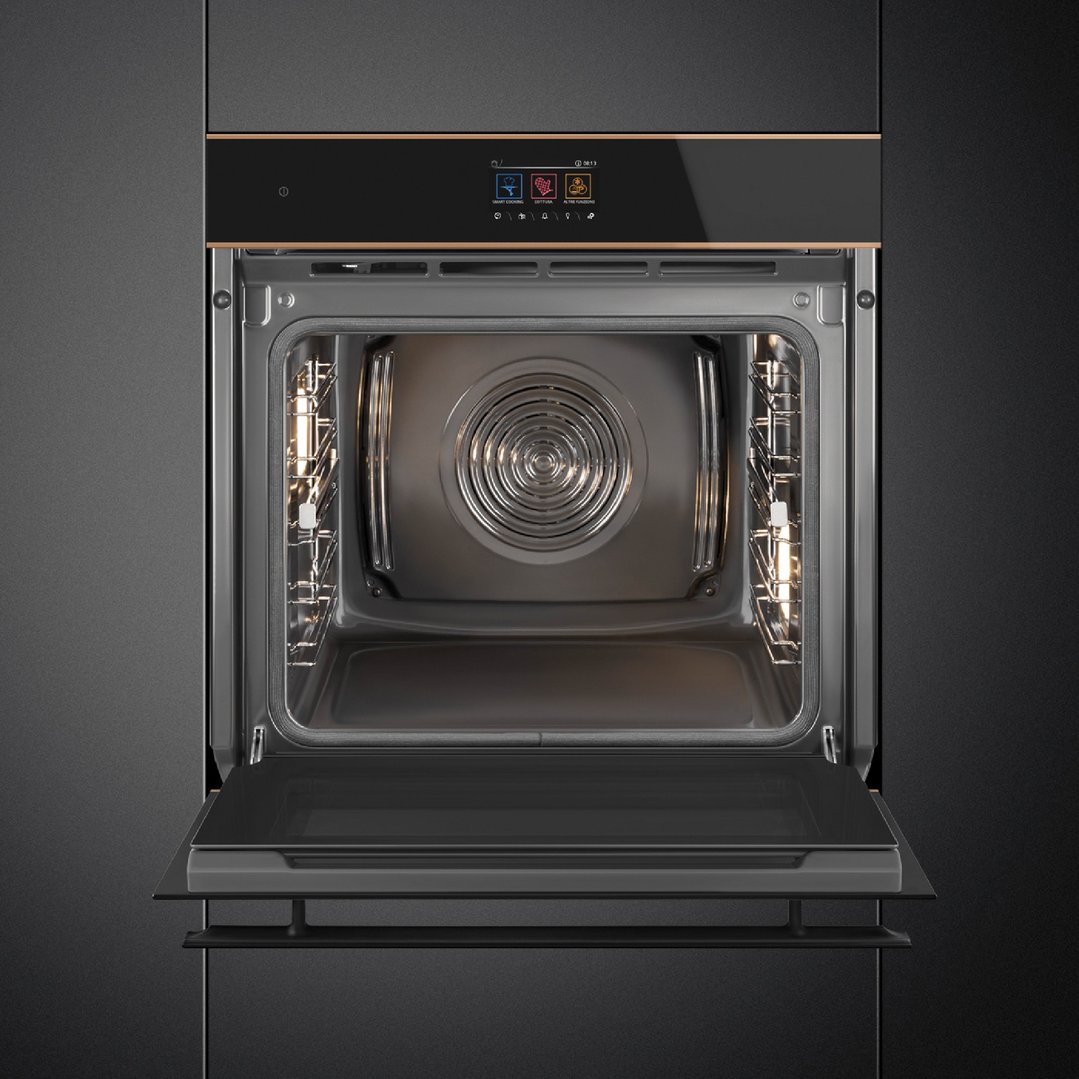 Black and copper trim oven with its door open, showing the interior