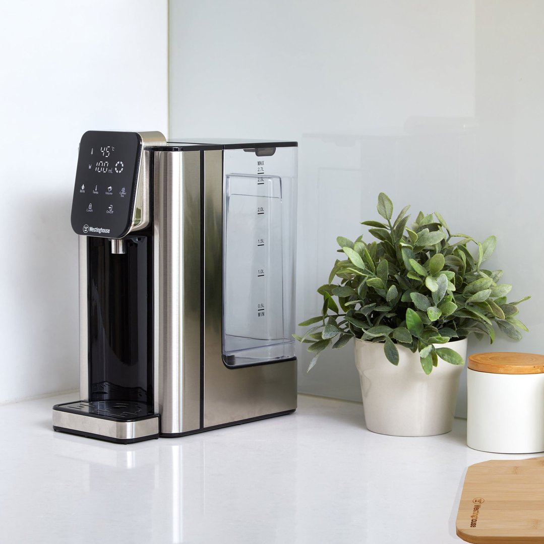 Instant Hot Water Dispenser on a white kitchen counter with a plant