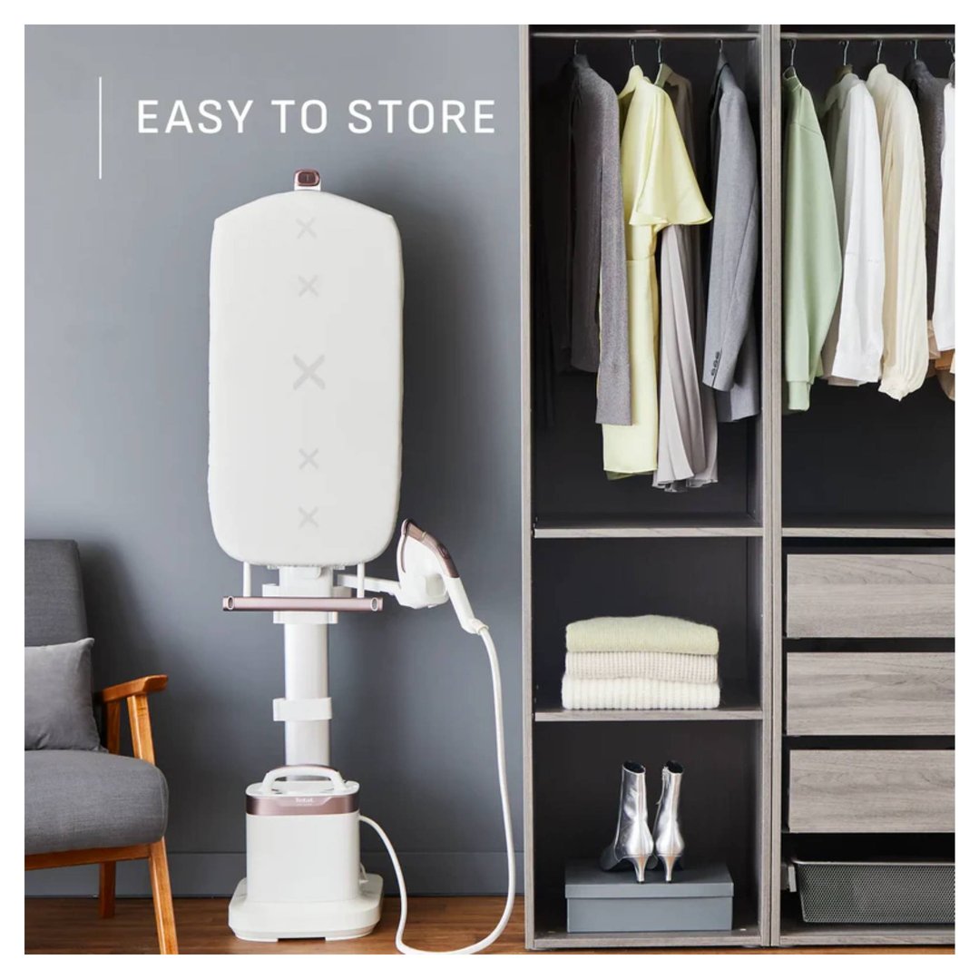 Garment steamer with ironing board next to a wardrobe with clothes and shoes