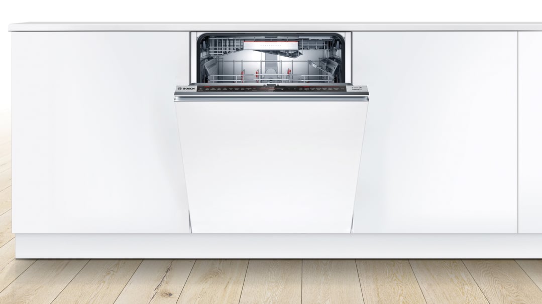 Fully-integrated Bosch dishwasher with door ajar in a white kitchen setting