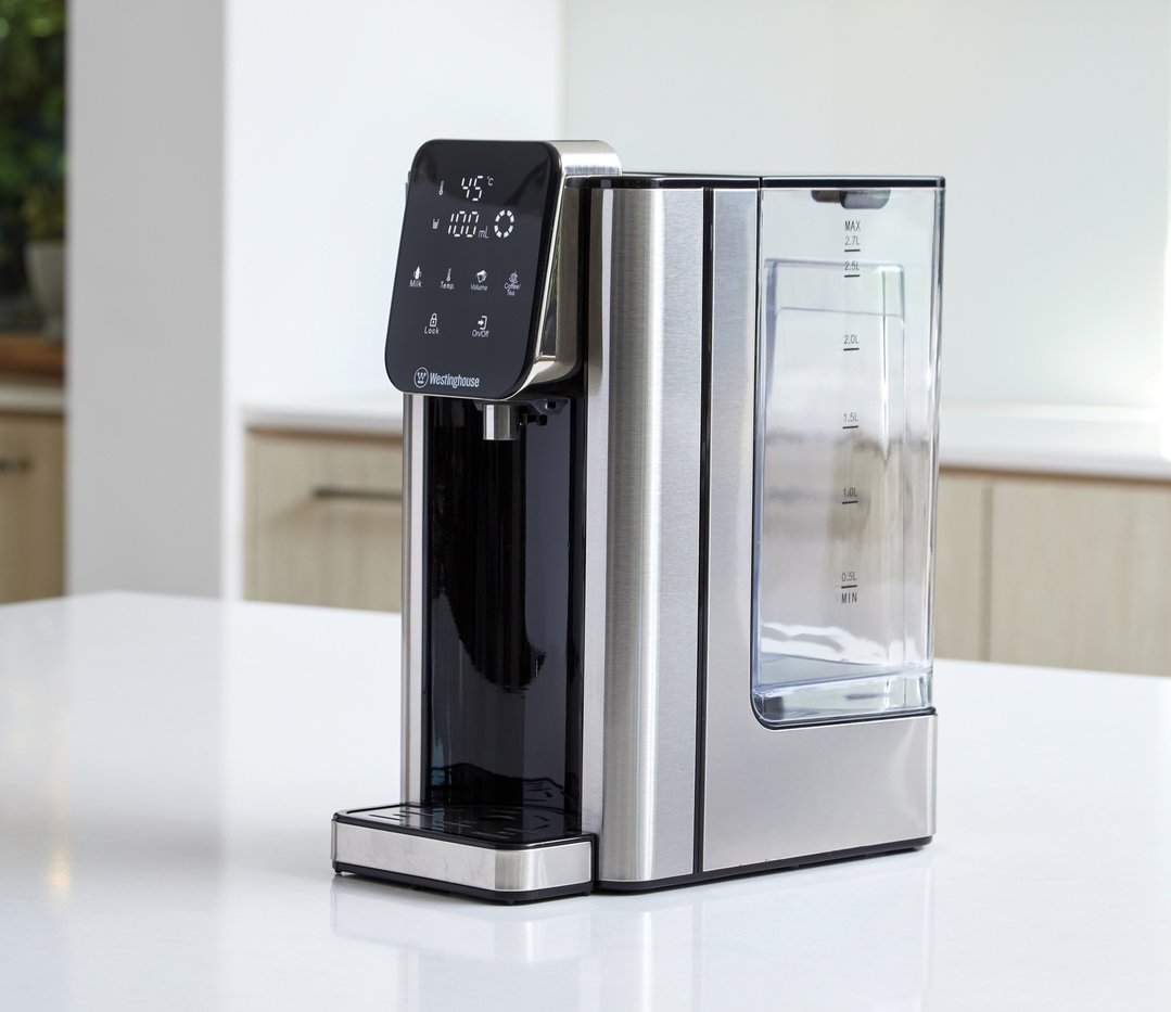Instant hot water dispenser on a white countertop in a kitchen