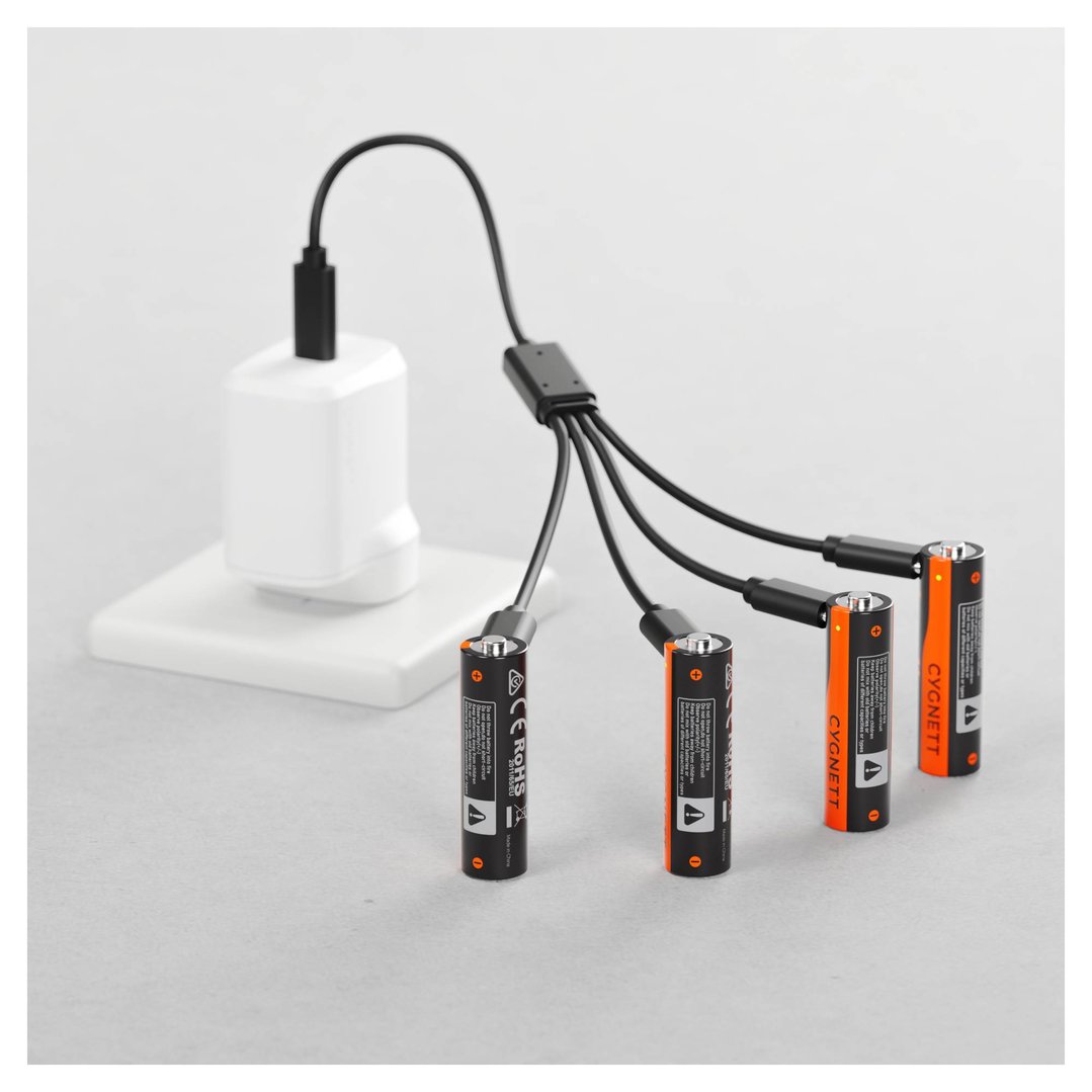 Four CYGNETT AA USB-C rechargeable batteries charging from a wall adapter