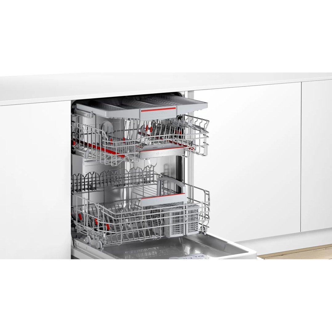 Open dishwasher with three racks pulled out in a modern kitchen setting