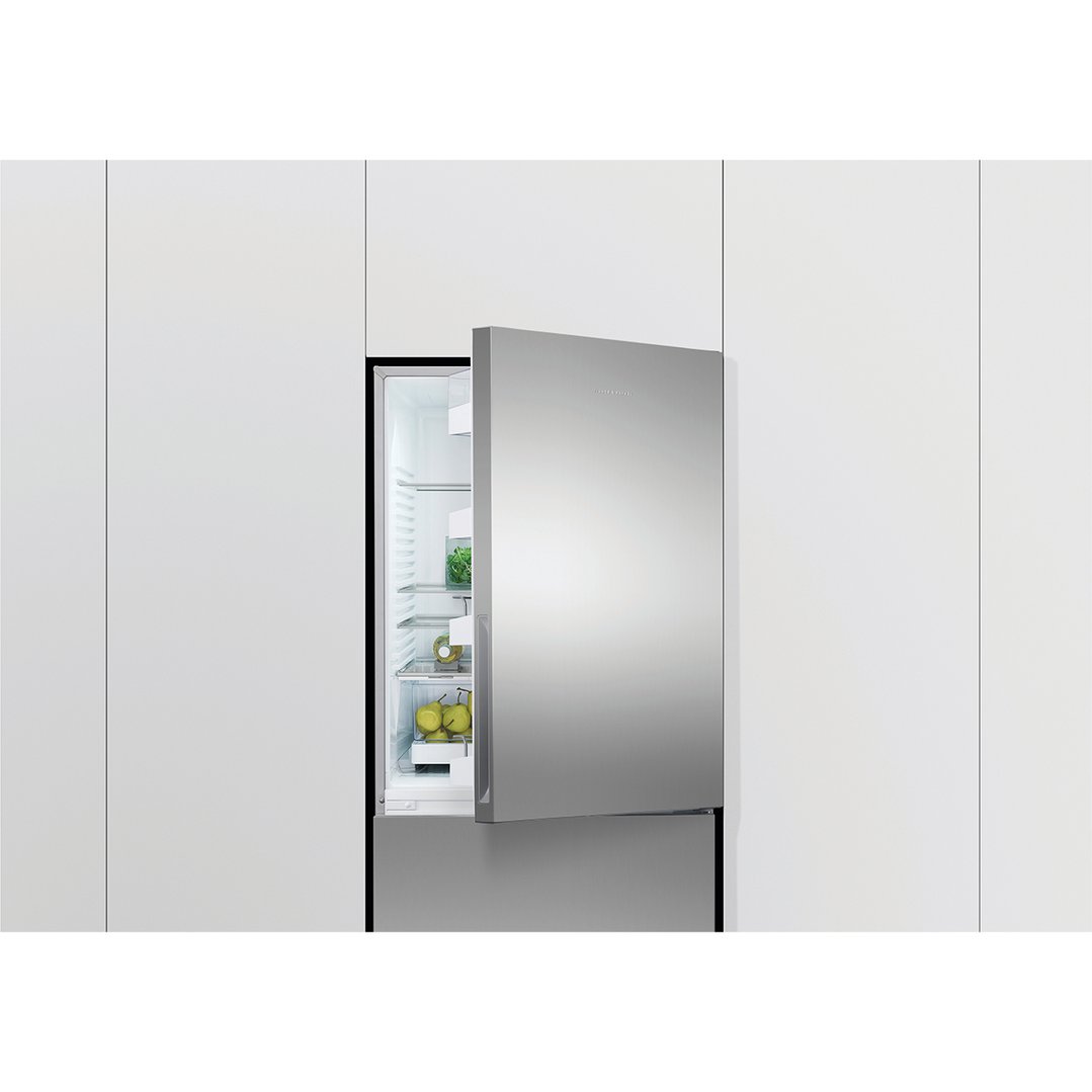 Refrigerator freezer with door open, showing interior shelves with food