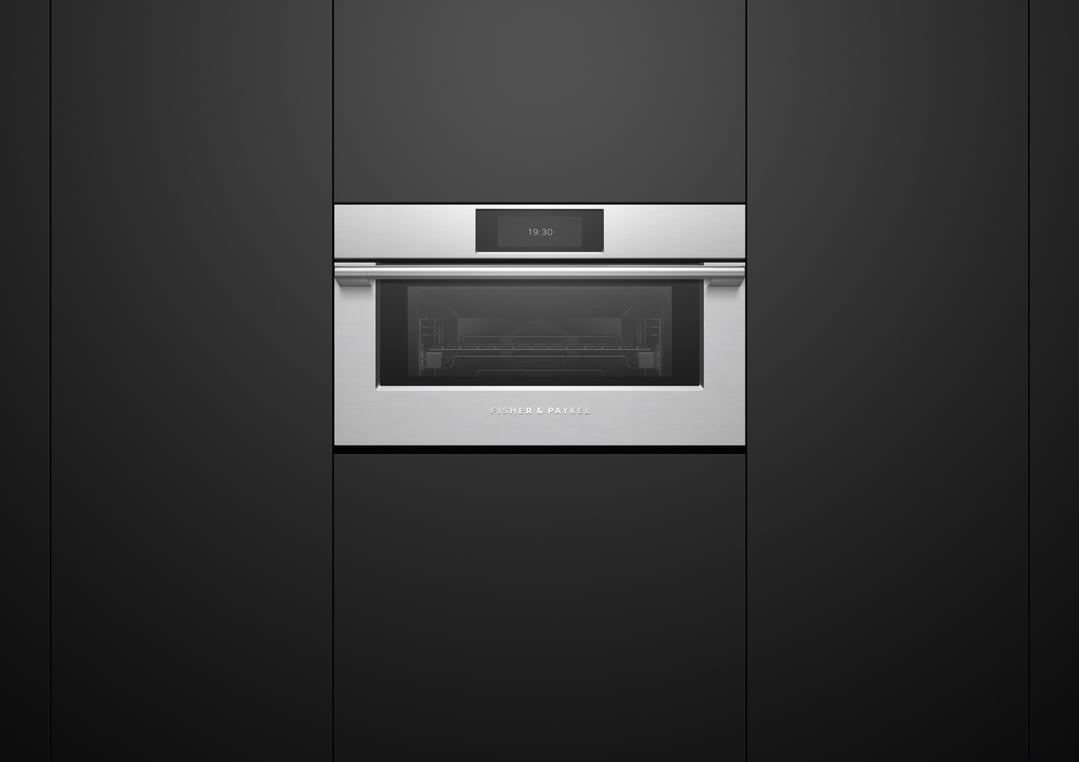 Stainless steel compact combi-steam oven built into dark cabinetry