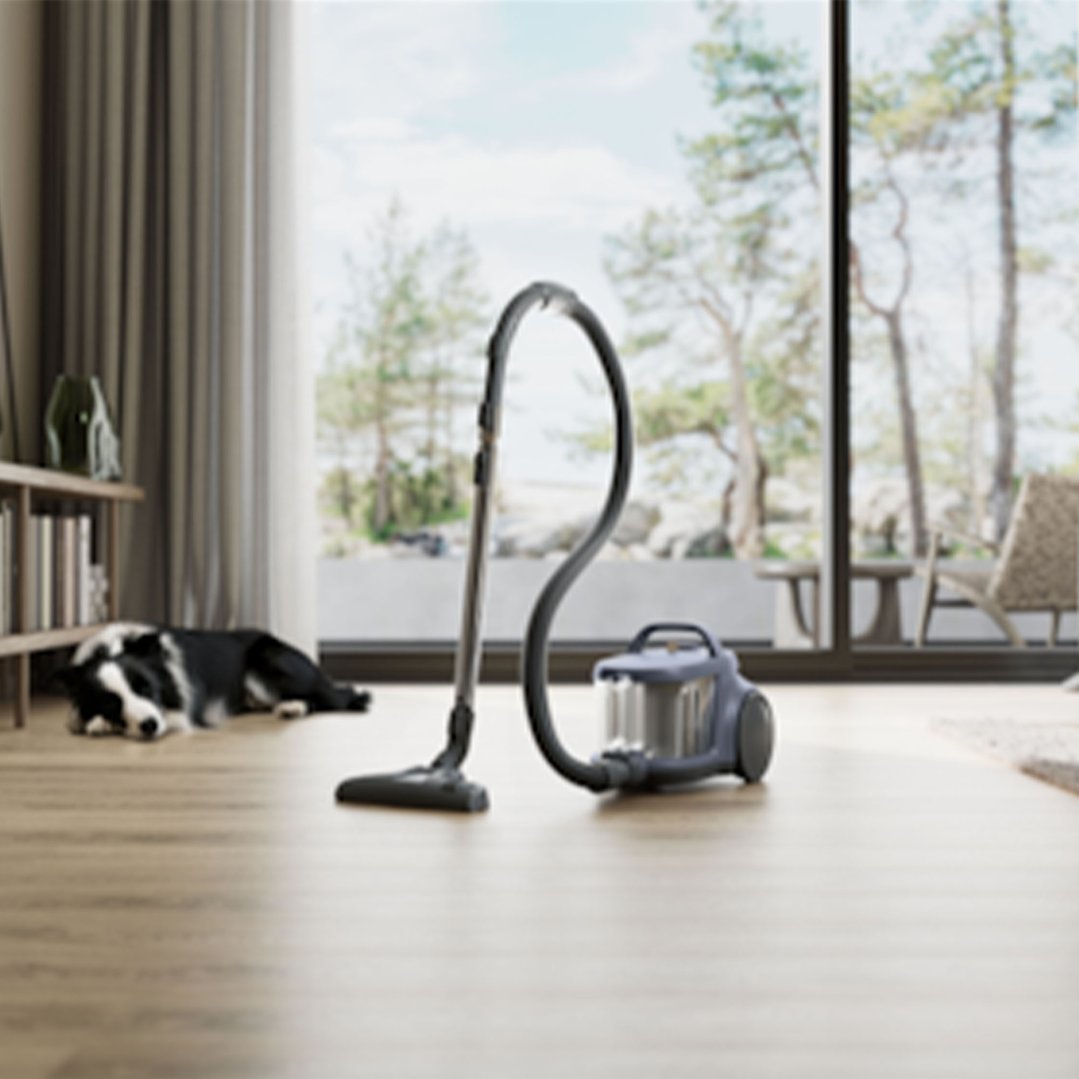 Vacuum cleaner on a wooden floor in a living room with a dog