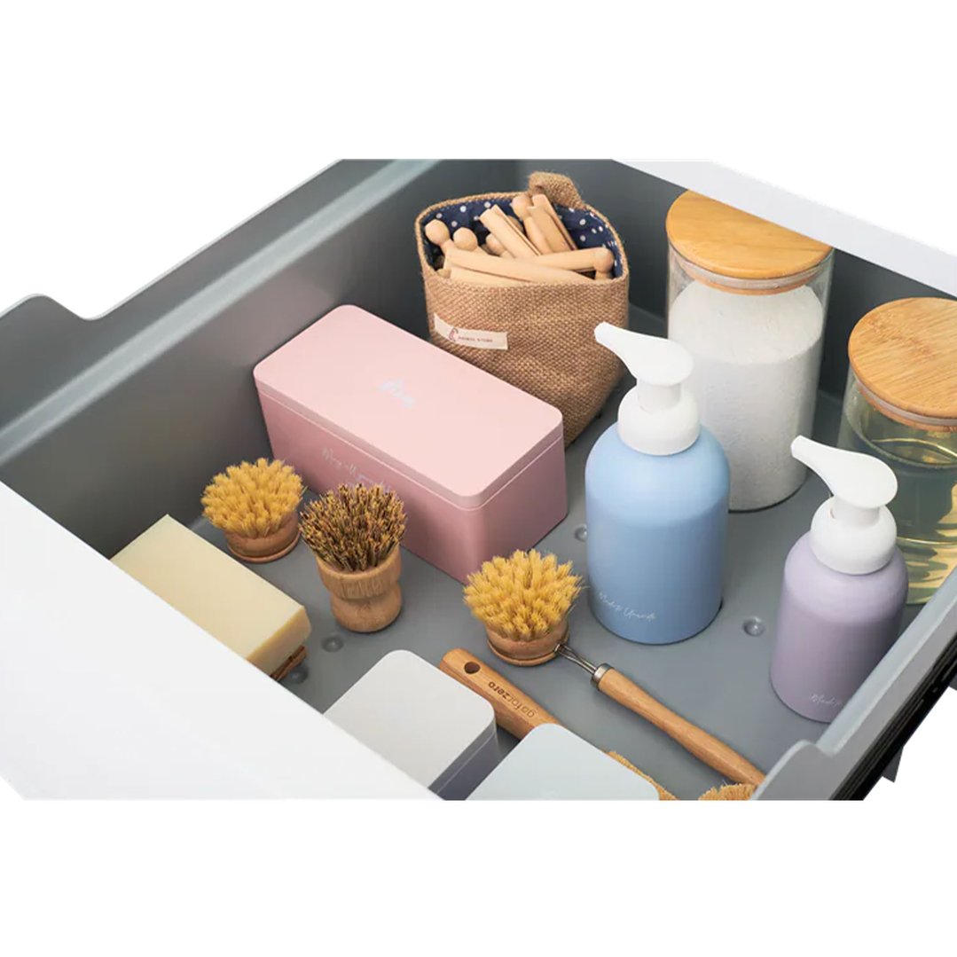 Close up of a laundry pedestal drawer filled with cleaning supplies