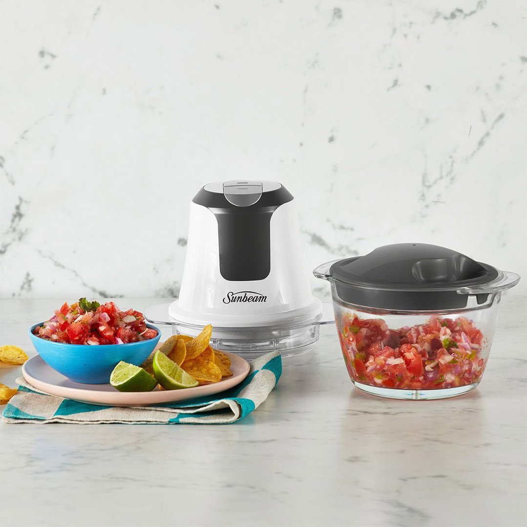 Sunbeam Mini Glass MultiChopper on a counter with salsa, chips, and lime wedges