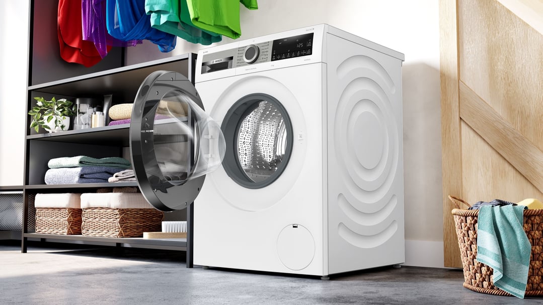 White front load washing machine with door open in a laundry room