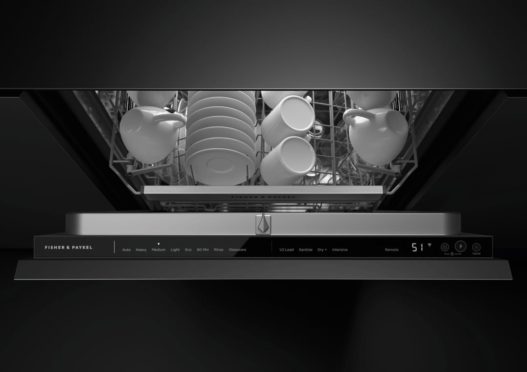 Integrated dishwasher with control panel visible, loaded with white dishes