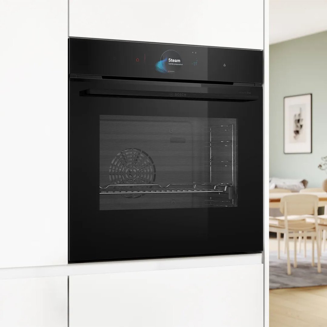 Black built-in oven with steam function in a modern kitchen setting