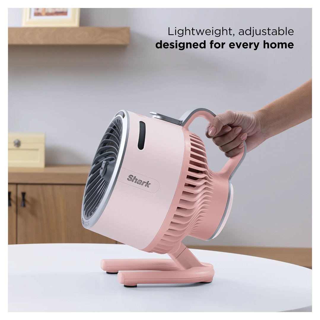 Hand holding a pink Shark fan on a white table with text overlay
