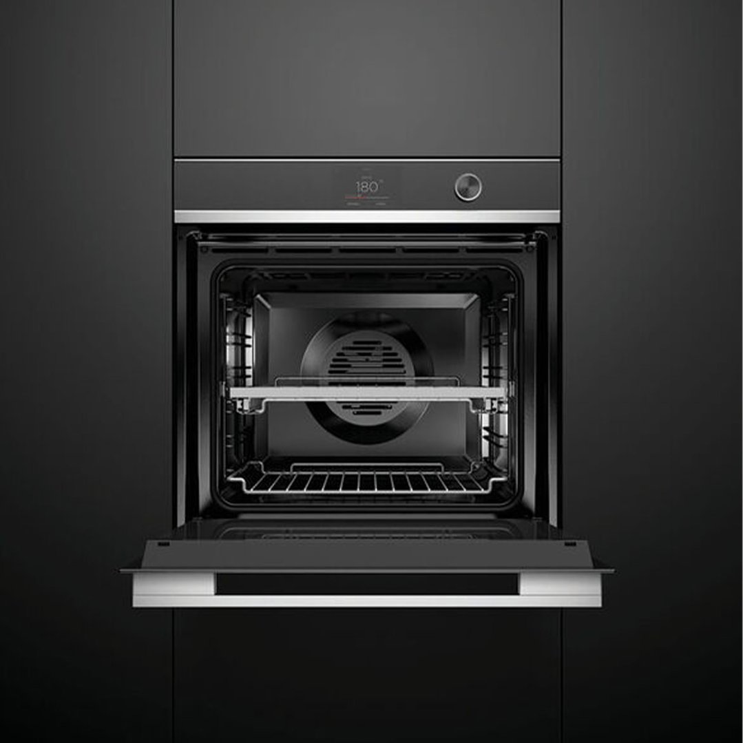 Black built-in oven with door open, showing interior racks and fan