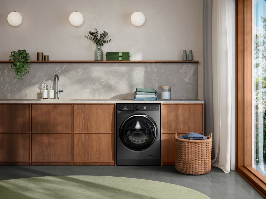 Dark Onyx front load washing machine in a modern laundry room