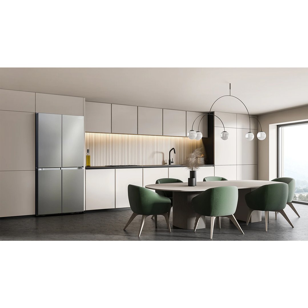 A silver French Door Fridge in a modern kitchen with a dining area