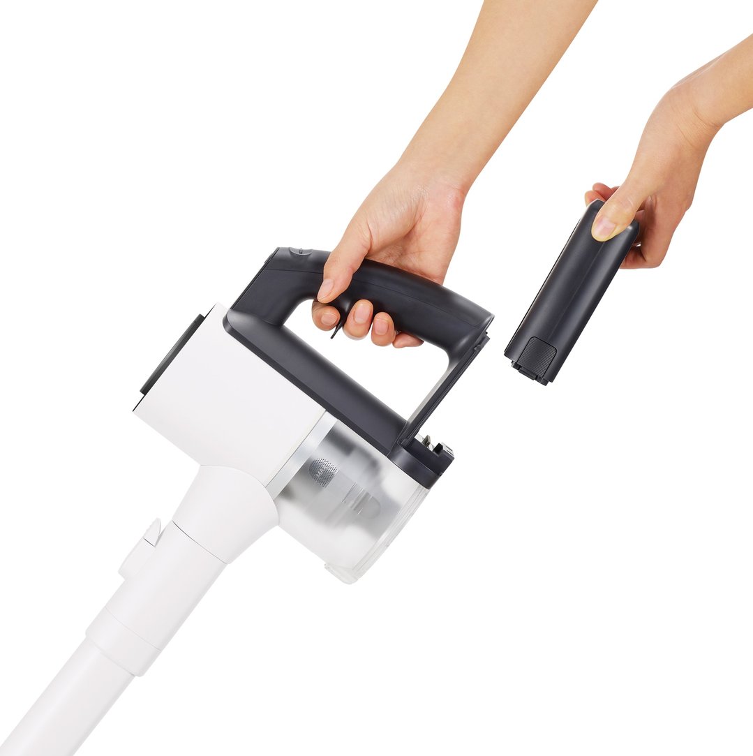 Hands inserting the battery into the CordZero Handstick Vac
